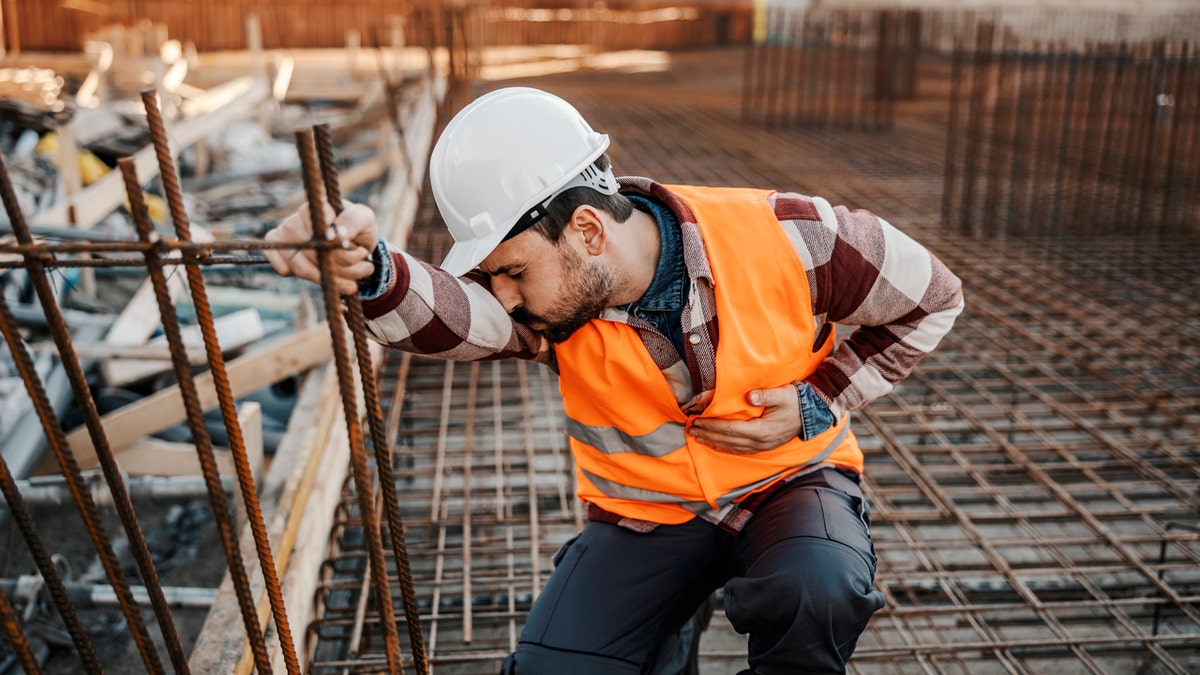 A construction worker with stomach pain