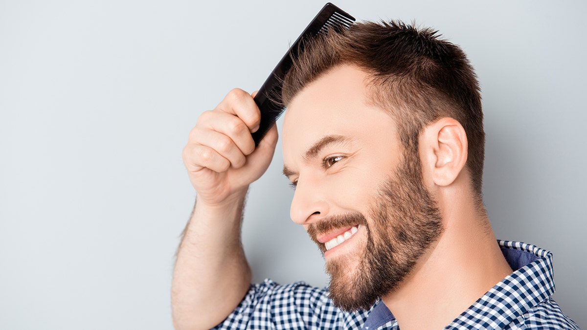 man combing his hair