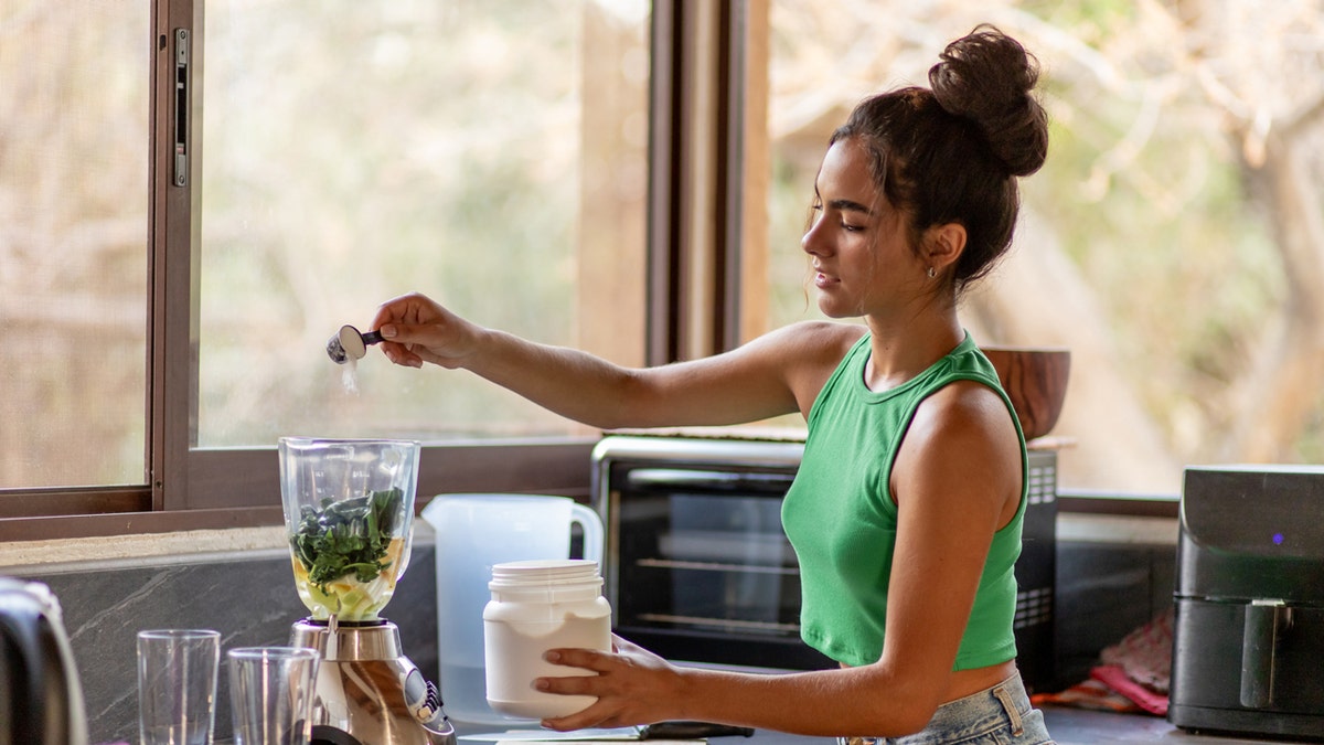 Woman making a protein shake