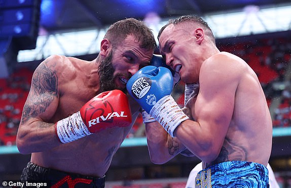 LONDON, ENGLAND - SEPTEMBER 21: Josh Warrington and Anthony Cacace exchanges punches during the IBO World Super Featherweight Title fight between Anthony Cacace and Josh Warrington, on the Riyadh Season  - Wembley Edition card at Wembley Stadium on September 21, 2024 in London, England. (Photo by Richard Pelham/Getty Images)