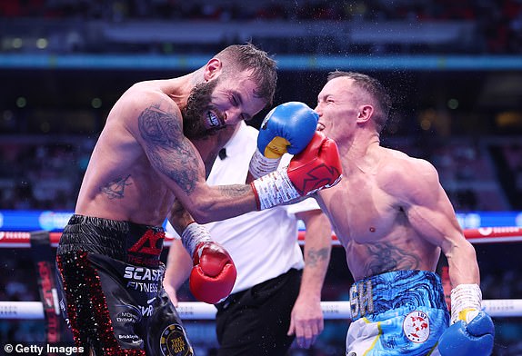 LONDON, ENGLAND - SEPTEMBER 21: Anthony Cacace and Josh Warrington exchange punches during the IBO World Super Featherweight Title fight between Anthony Cacace and Josh Warrington, on the Riyadh Season  - Wembley Edition card at Wembley Stadium on September 21, 2024 in London, England. (Photo by Richard Pelham/Getty Images)