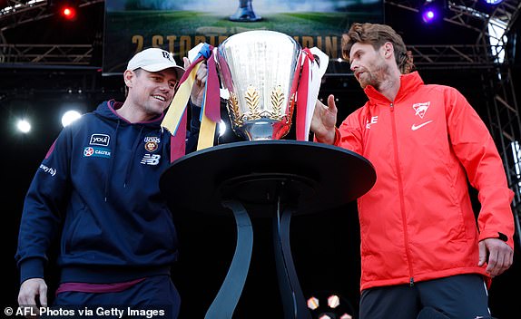 MELBOURNE, AUSTRALIA - SEPTEMBER 27: Lachie Neale of the Lions is the last to touch the cup as Dane Rampe of the Swans looks on during the 2024 AFL Grand Final Parade on September 27, 2024 in Melbourne, Australia. (Photo by Michael Willson/AFL Photos via Getty Images)