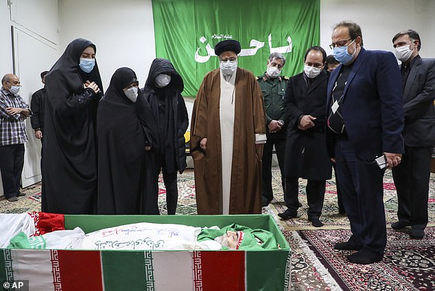 FILE PHOTO: Iran's Judiciary Chief Ayatollah Ebrahim Raisi pays his respect to the body of slain scientist Mohsen Fakhrizadeh among his family, in Tehran, Iran, Saturday, Nov. 28, 2020