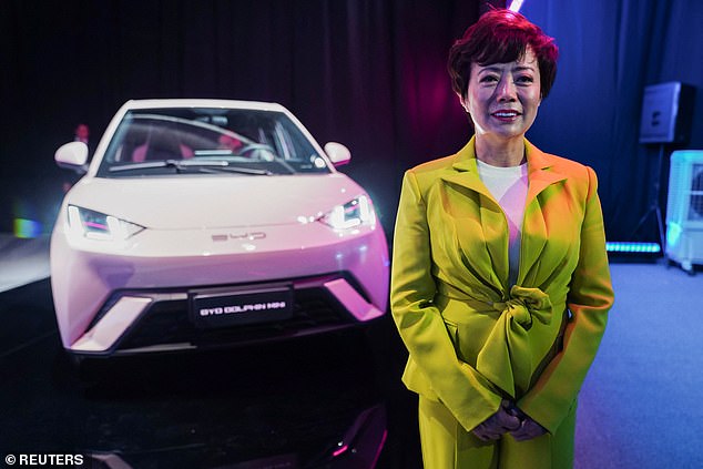 Pictured is BYD Americas executive Stella Li with a BYD Dolphin electric vehicle