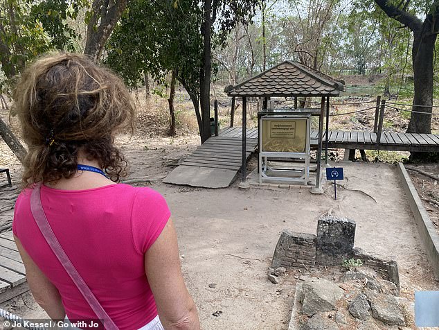 Jo is pictured at the Killing Fields on an excursion from Phnom Penh, Cambodia, which she describes as an 'emotionally intense visit' but the 'best way to fully understand the horrors this country has endured'