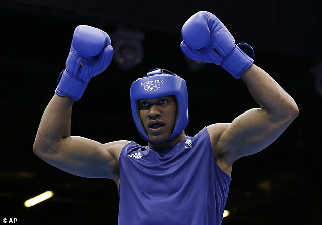 Joshua reacts after beating Italy's Roberto Cammarelle for the gold medal in a super heavyweight over 91-kg gold medal boxing match at the 2012 Summer Olympics