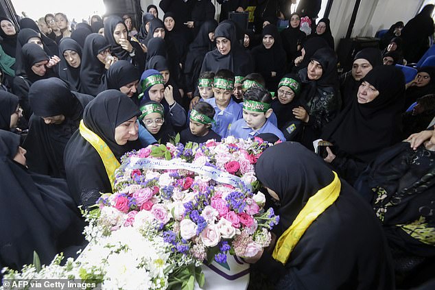 Relatives mourn Fatima Abdallah, a young girl killed after thousands of paging devices exploded in a deadly wave across Lebanon, during her funeral in the village of Saraain in the Bekaa valley on September 18, 2024