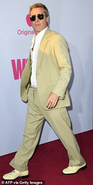 Brad was dapper in a pair of tan trousers as well as a matching blazer that was left unfastened at the front