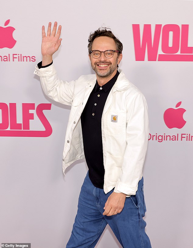 Nick Kroll sent a friendly wave on the red carpet while donning a pair of blue pants as well as a black polo shirt