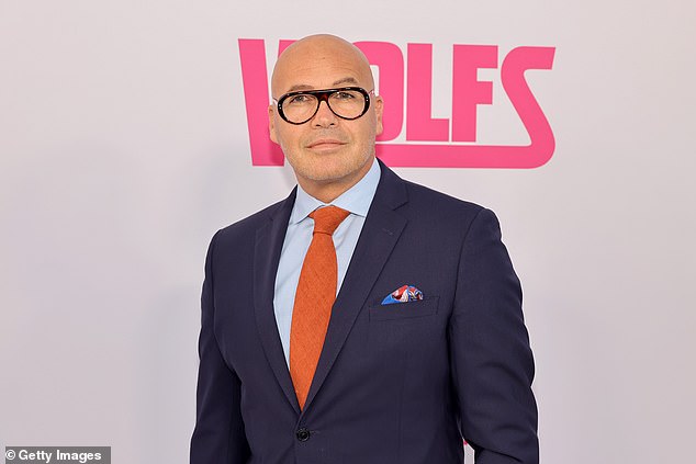 Billy Zane was dapper in a dark navy suit which was paired with a light blue, dress shirt as well as an orange tie that added a pop of color