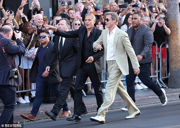 Brad and George were seen strolling down a portion of Hollywood Boulevard that had been shut down for the premiere