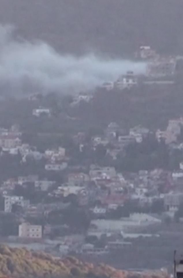 Heavy smoke lingers over a settlement after a second wave of explosions rocked Lebanon