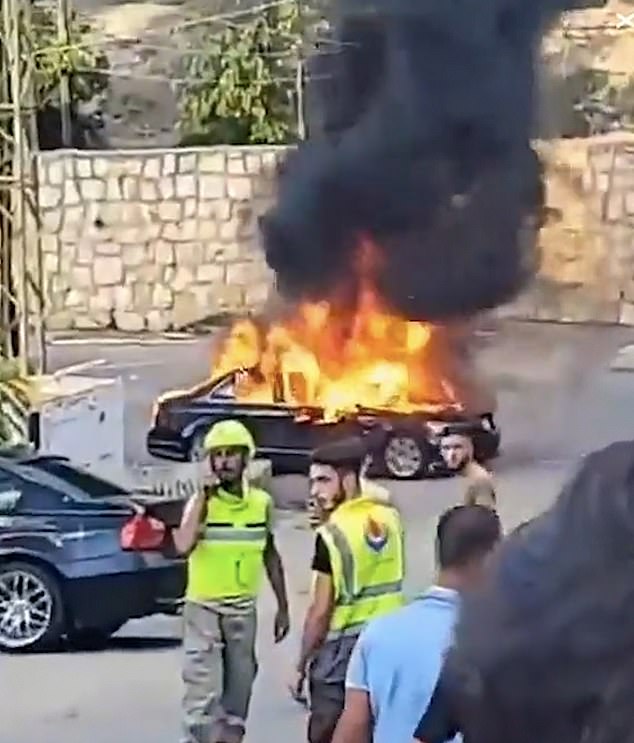 A car burns on the streets of Lebanon following an explosion