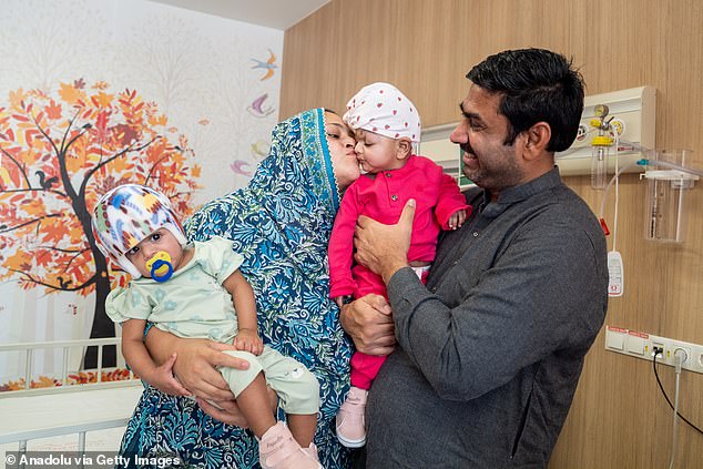 Father Rehan Ali and mother Nazia Parveen celebrate the success of the surgery