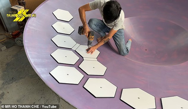 By layering fibreglass over the mould, the builders create a dish-like shape. Mr Ho then attaches a pattern of hexagonal boards to provide structure and mark the location of future panels