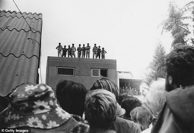 Observers watch from a rooftop as rescued Israeli hostages arrive at Ben Gurion Airport near Tel Aviv, on their return to Israel after Operation Entebbe