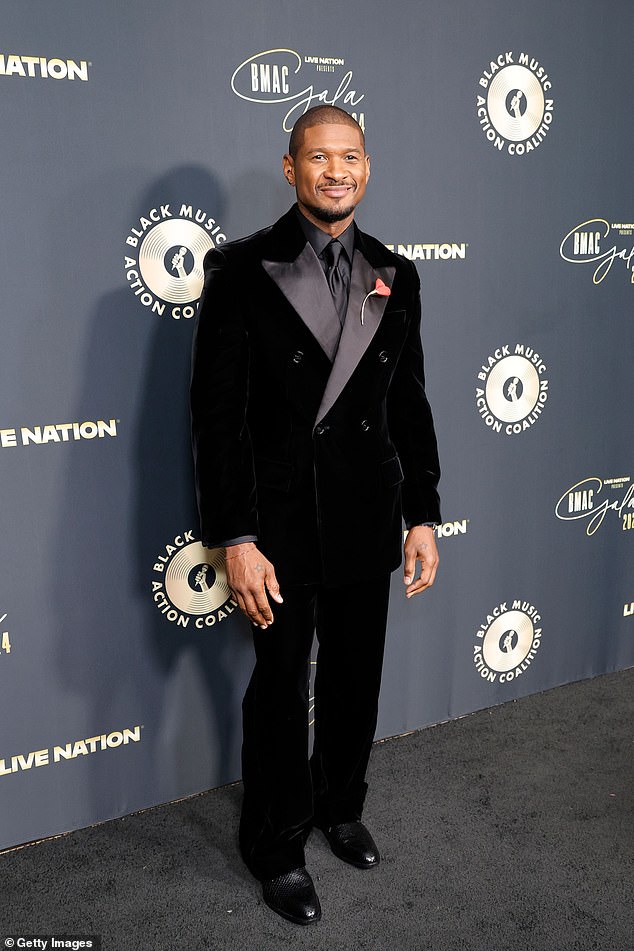 He wore a delicate pink flower pinned to his lapel, and he matched the tuxedo with shiny black snakeskin shoes