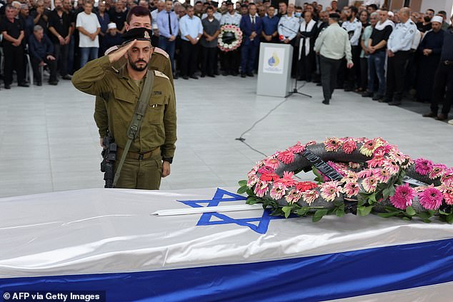 Israeli soldiers stand in attention in front of the flag-draped coffin of reservist Major Nael Fwarsy, 43, killed a day earlier near Israel's northern border with Lebanon