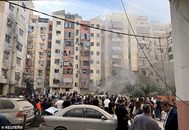 Crowds gather at the site of an Israeli strike in the southern suburbs of Beirut, Lebanon, September 20, 2024