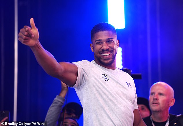 Joshua was all smiles as he emerged to roars of support at Trafalgar Square for the weigh in