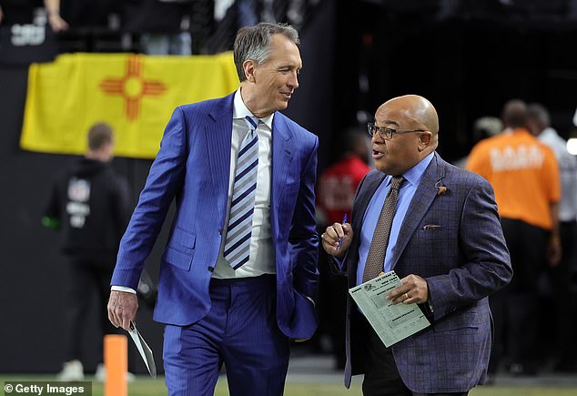 Collinsworth is seen with his on-air partner, NBC Sports announcer Mike Tirico (right)