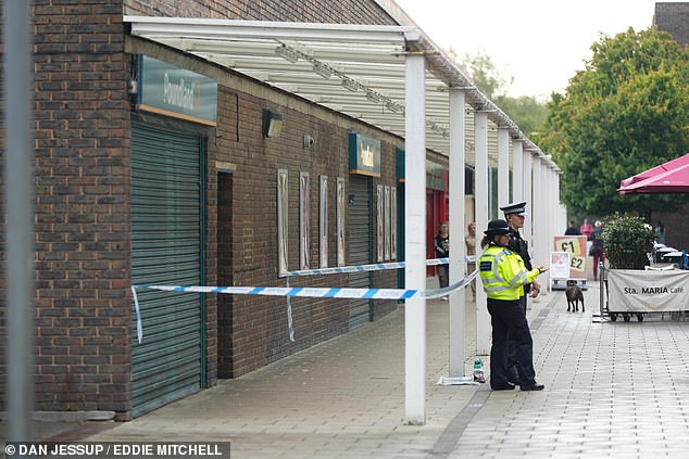 Police stand at the scene of an alleged rape that took place in the early hours of Saturday morning