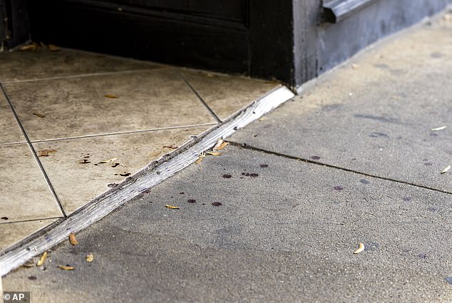 Drops of blood remain at the scene of a fatal Saturday night shooting