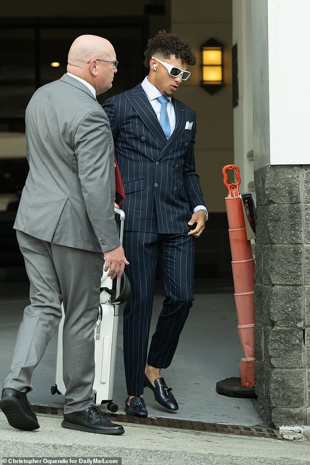 Patrick Mahomes also got dressed up as he wore a pinstriped navy suit and a baby blue tie