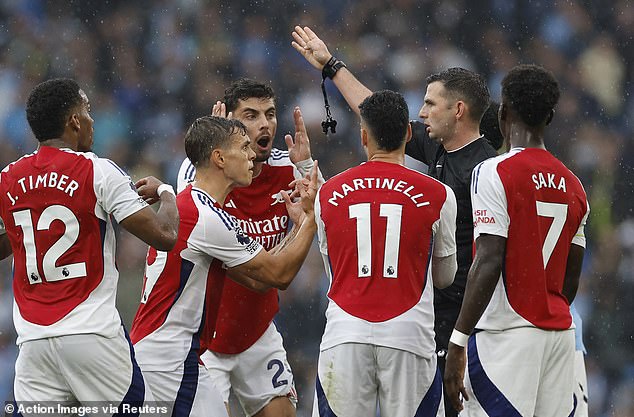 The official dismissed Leandro Trossard (second from left) for time wasting just before the interval against Man City