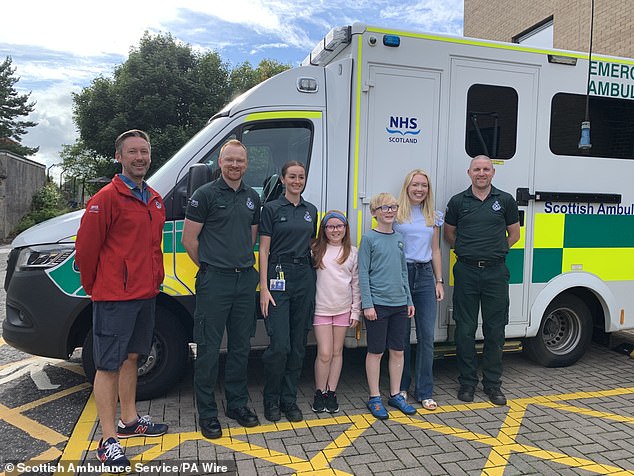 Scottish Ambulance staff with Arianna Liddle (centre), her brother Oliver (centre right) and their mother, Donna (second right)