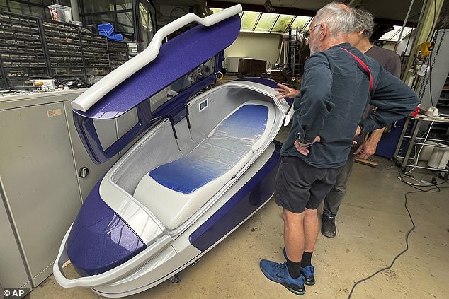 Philip Nitschke, front, stands next to a 'suicide pod' known as 'The Sarco' in Rotterdam, The Netherlands, July 8, 2024