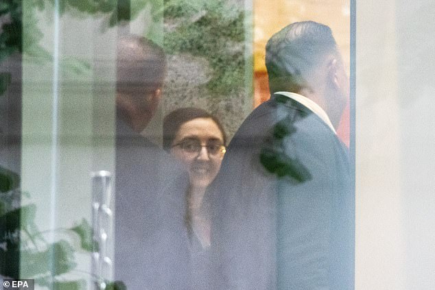 Ellison pictured Tuesday in the entrance of the Manhattan courthouse flashing a brief smile