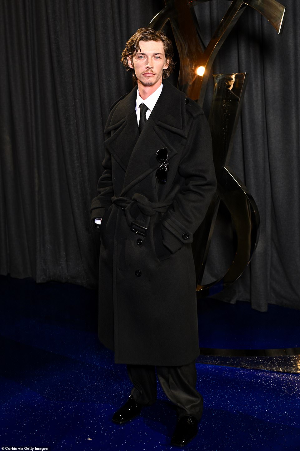 Actor Jacob Lofland followed the men also wearing a black trench coat