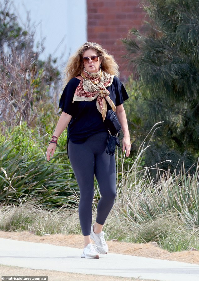 She also wore a variety of colourful necklaces and brightly-patterned scarf tied around the strap of her bag.