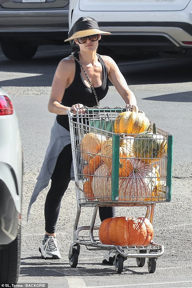 Garcia was pictured with a grocery cart loaded with pumpkins of all sizes as fall commences