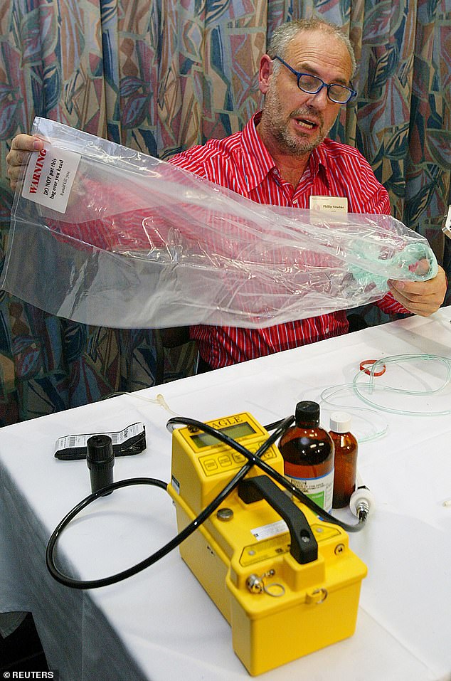 Dr Nitschke holds one of his Exit Bags during a demonstration of its operation at a suicide conference titled 'Killing me Softly' in Sydney, Australia, May 31, 2003