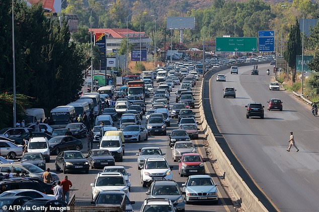 Vehicles wait in traffic in the town of Damour, south of the capital Beirut on September 24, 2024, as people flee southern Lebanon