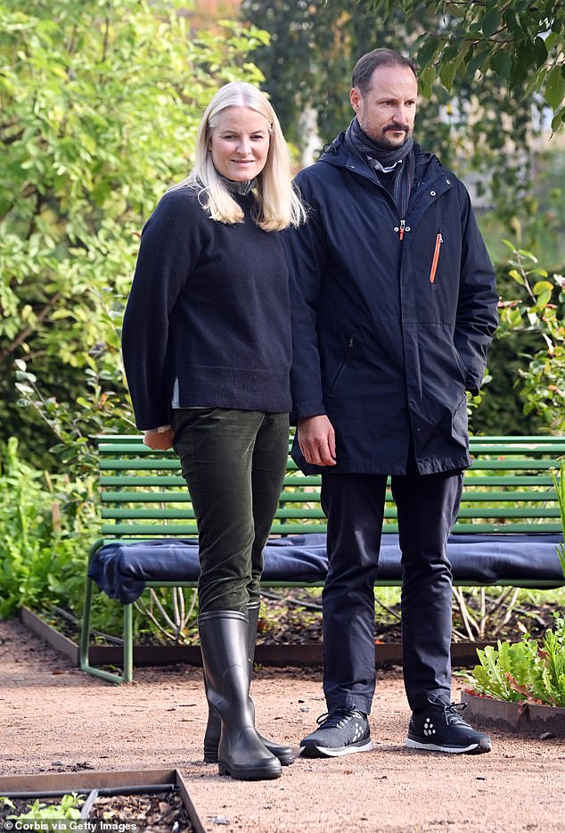 The couple dressed in practical black outfits as they visited the farm