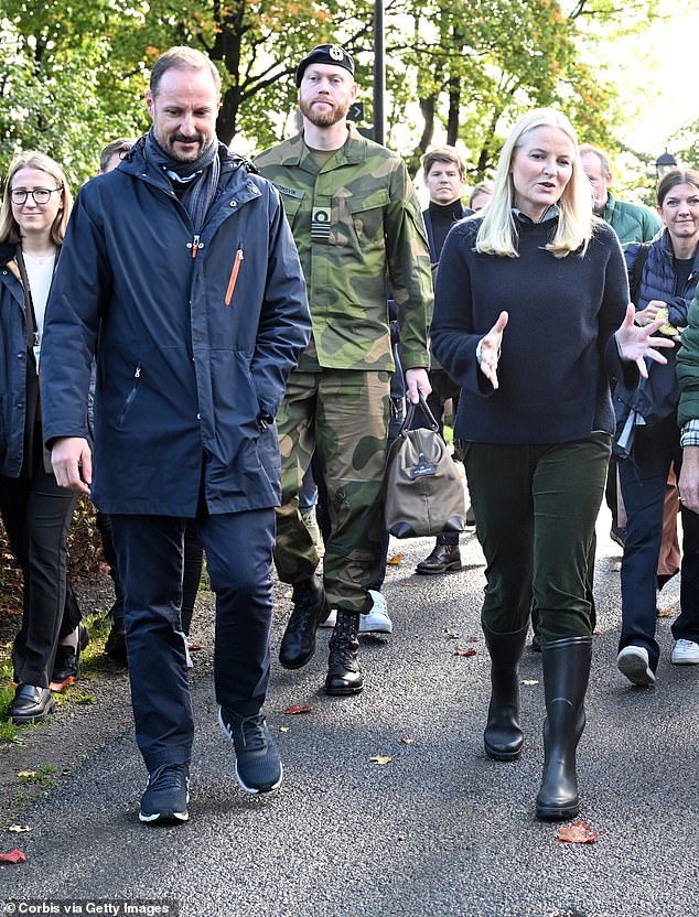 Crown Prince Haakon and Crown Princess Mette-Marit chatted to staff members as they walked through the farm