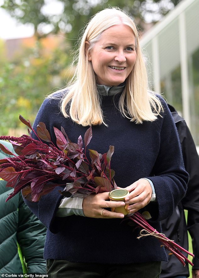 Mette-Marit, whose son Marius is under intense scrutiny from the Norwegian press at the moment, smiled as she held a bunch of flowers