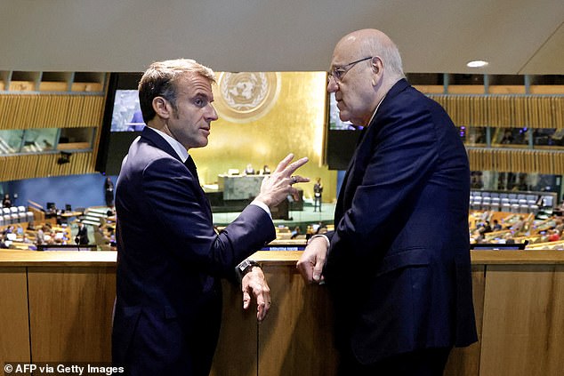 French President Emmanuel Macron (L) speaks with Prime Minister of Lebanon Najib Mikati on the sidelines of the 79th Session of the United Nations General Assembly in New York on September 25, 2024