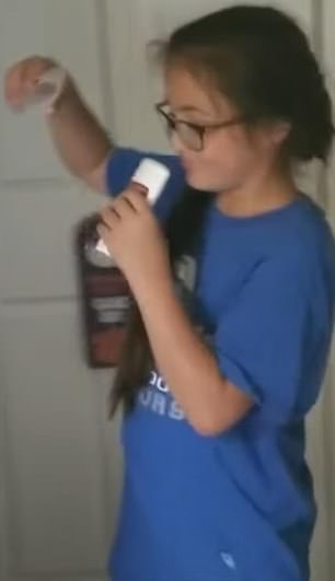 The above shows a young girl sniffing on a roll-on deodorant while trying chroming