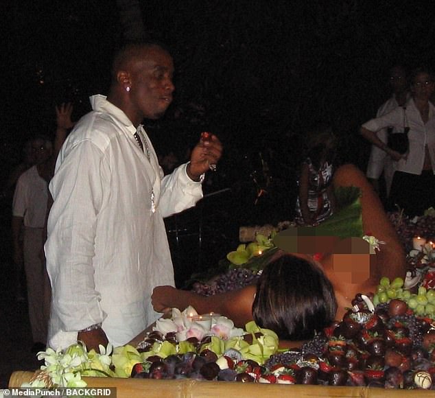 In the images Diddy, who was 34 at the time, is seen enjoying a chocolate-covered strawberry from a nude woman, who is seen serving as the centerpiece of a food platter