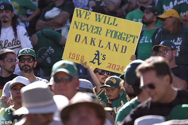 An A's fans holds up a sign after the Oakland Athletics defeated the Texas Rangers