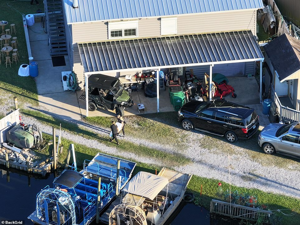 The home situated near the water had a golf cart, trash bins and lawn equipment stored on the patio