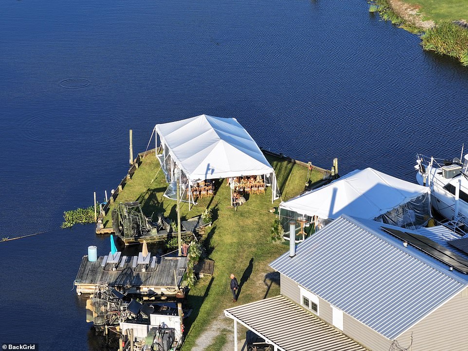 The various tents situated along the water had wooden tables and chairs with white table cloths