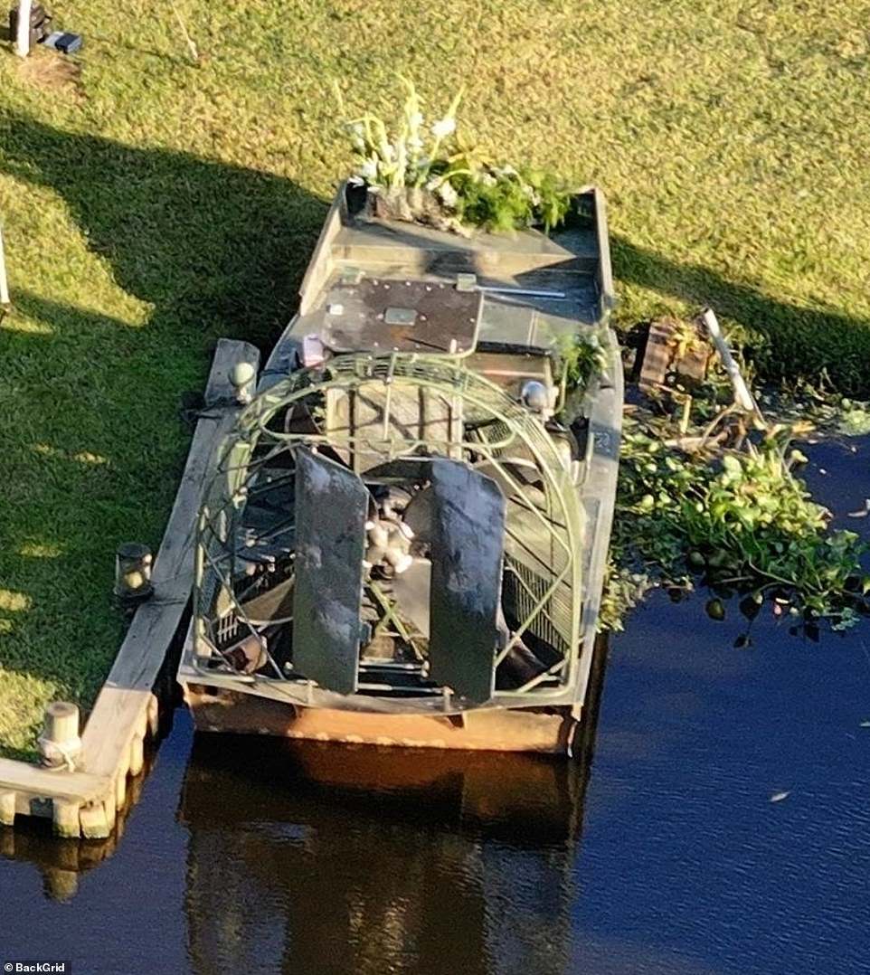 The newlyweds walked past one of Dufrene's famous swamp air boats, which was tied to the dock and decorated with white flowers for the couple's special day