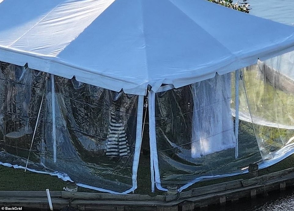 A white curtain blocked the bride and groom from view