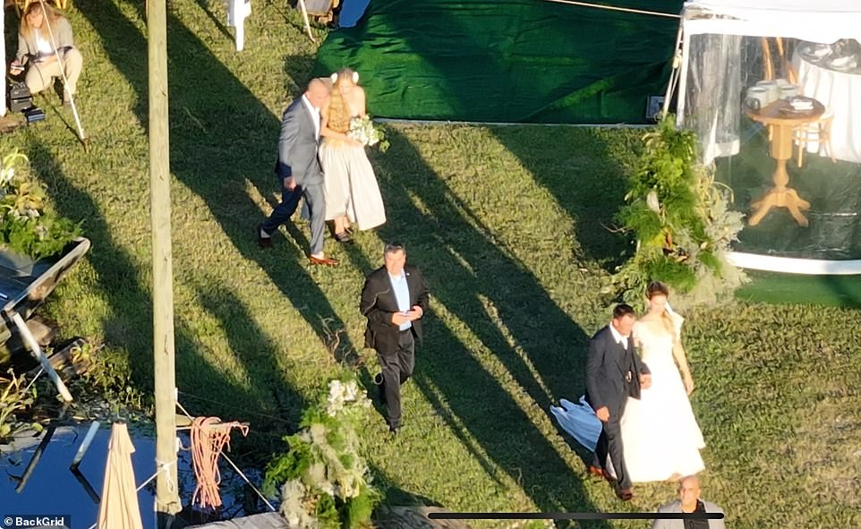 After saying 'I Do,' Dufrene — a Louisiana native and divorced father-of-three — grabbed onto Lana's hand as they made their way to the outdoor reception