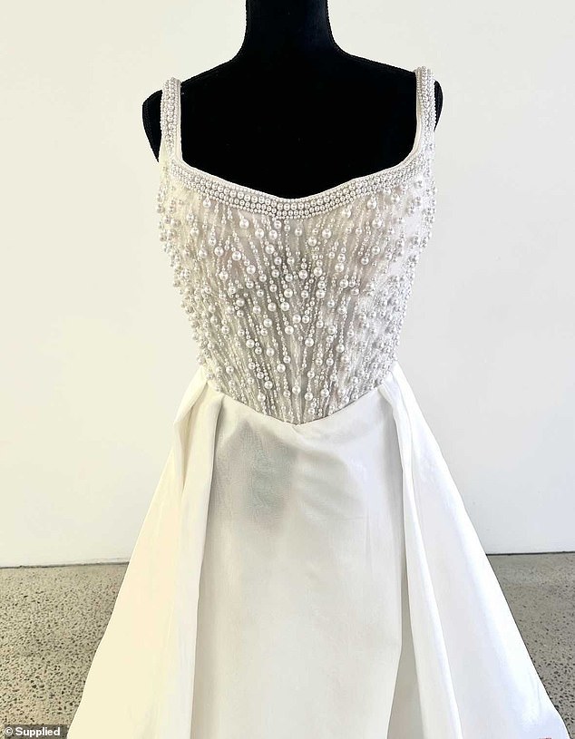 Pictures of the gown designed by Champery Couture (pictured) show it features an extravagant pearl and beaded bodice with a floating layered skirt